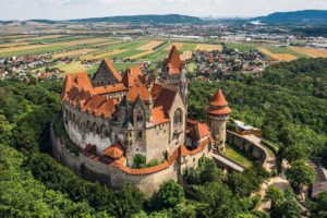 Aerial view of castle amidst the woods.